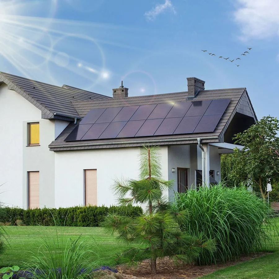 Modern UK home with solar panels on rooftop — beautiful sunny day